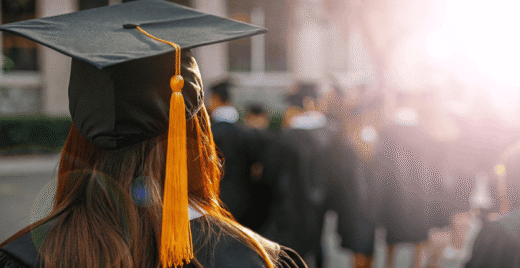 Graduate looking at classmates
