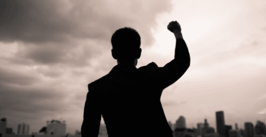 Men with high fist looking at the sky