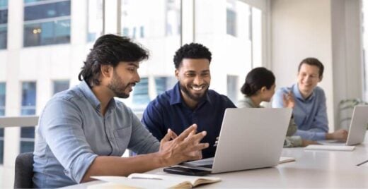 Two men discussing business at a table together.